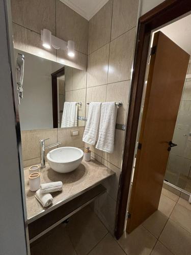 a bathroom with a sink and a large mirror at The View in Villa General Belgrano