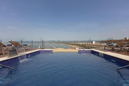 a large swimming pool with a water fountain at Hotel Las Vegas in Salou