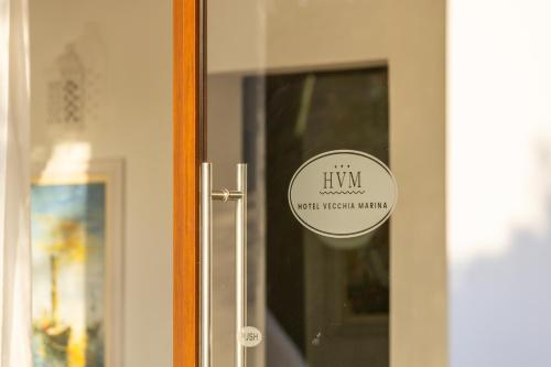 a door with a sticker on the glass at Hotel Vecchia Marina in Àrbatax