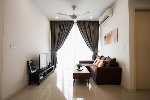 a living room with a couch and a television at D'Pristine Medini, Iskandar Puteri Johor Bahru Walk to Legoland & Gleneagles in Iskandar Puteri
