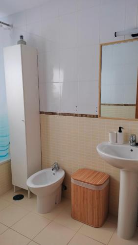 a bathroom with a sink and a toilet and a bidet at La casita de Taty in Majanicho