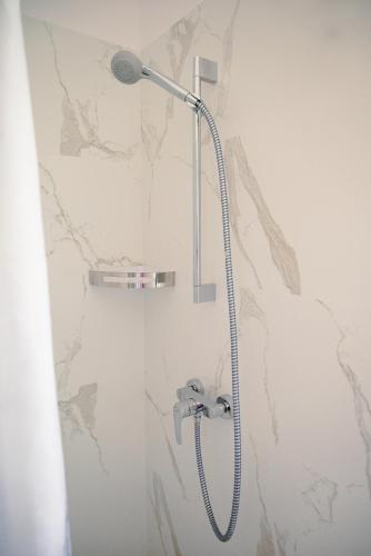 a shower with a shower head in a bathroom at Apartmani Natalija 4 Stars in Mrljane