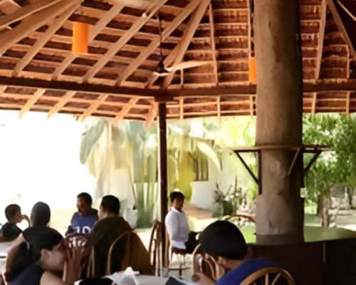 a group of people sitting at a table at Ronne's Little Baga service apartments in Goa