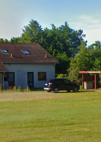 a car parked in front of a house at Cozy Apartment in Billund in Billund