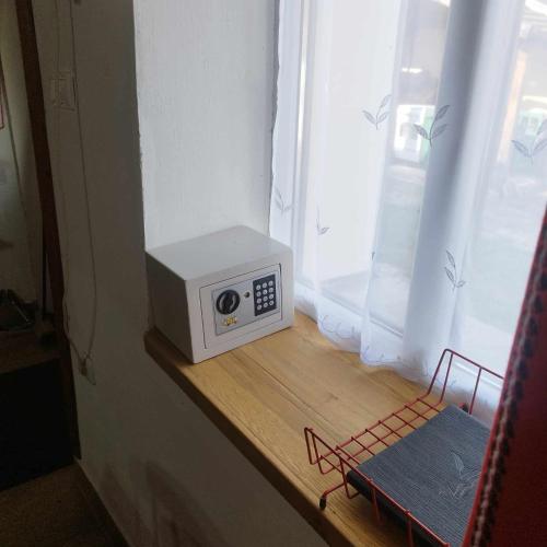 a microwave sitting on a counter next to a window at Zempléni Szálláshely in Fony