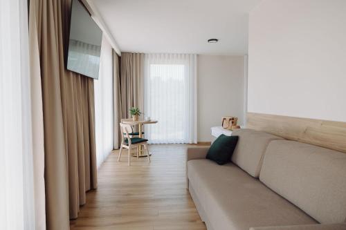 a living room with a couch and a table at Jezioranka Apartamenty in Ostrzyce