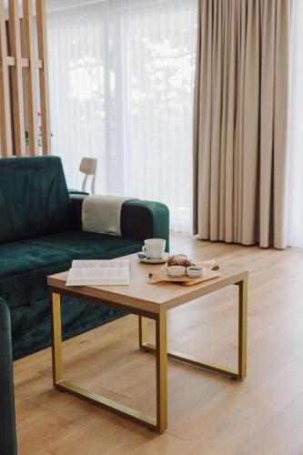 a living room with a coffee table and a couch at Jezioranka Apartamenty in Ostrzyce