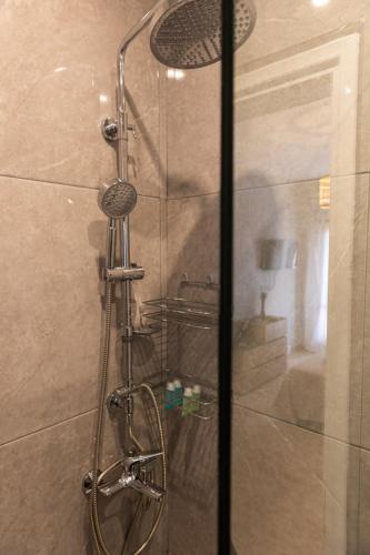a shower with a glass door in a bathroom at Sea side in Pteleós
