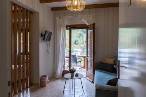 a living room with a couch and a table at Sea side in Pteleós