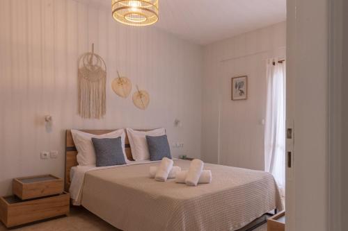a bedroom with a bed with two towels on it at Sea side in Pteleós