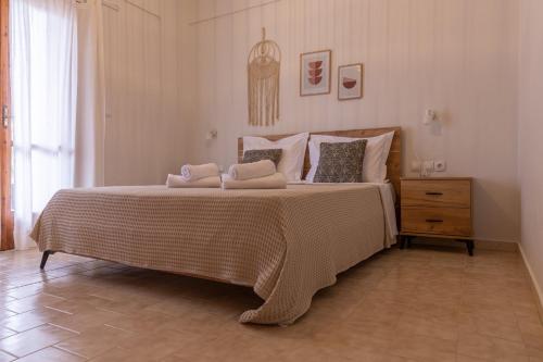 a bedroom with a large bed with two pillows on it at Sea side in Pteleós