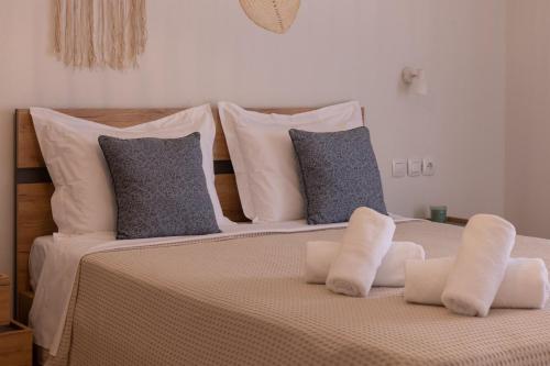 a bedroom with a bed with white pillows at Sea side in Pteleós