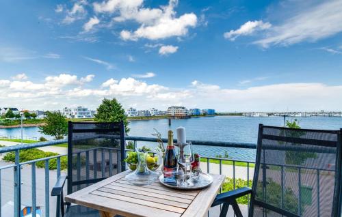 a table on a balcony with a view of the water at Segler Nest in Olpenitz