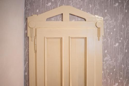 a wooden door in a room with a wall at Vila Heide in Česká Kamenice