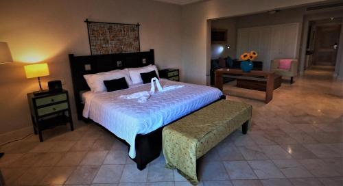 a bedroom with a large bed and a chair at Propiedad Fishing Lodge in Punta Cana