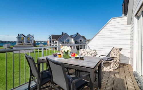 a table and chairs on the deck of a house at Strand 11 in Olpenitz
