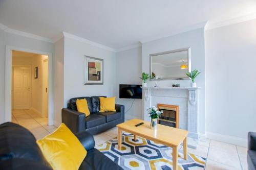 a living room with a couch and a fireplace at 17 - Spacious 2 Bed Apt with Parking in Galway