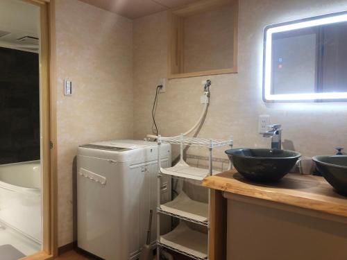a bathroom with a sink and two sinks and a tub at 静雅の宿 in Kyoto