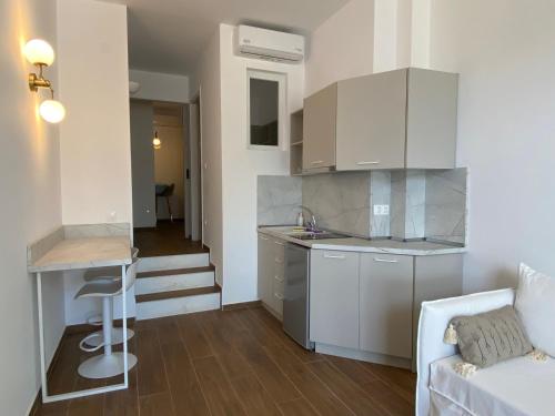 a kitchen and a living room with a couch at Nostos in Patitiri