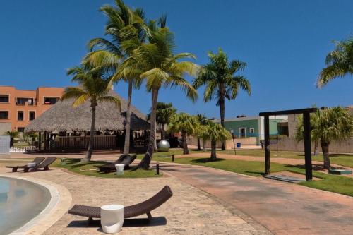 a resort with palm trees and a swimming pool at Propiedad Fishing Lodge in Punta Cana