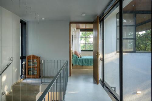 a hallway of a house with a bedroom at SaffronStays Jade in Kārli
