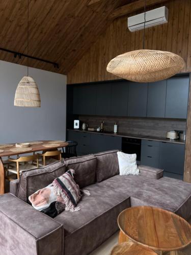 a living room with a couch and a table at Stodoły Trzy Żywioły in Prusim