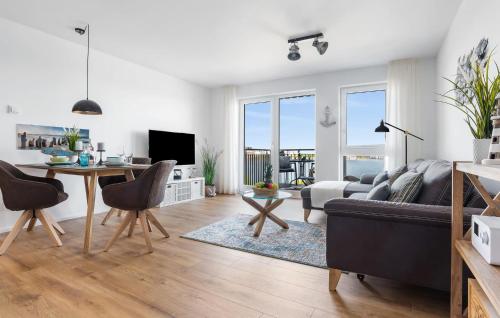 a living room with a couch and a table at Strandläufer in Olpenitz