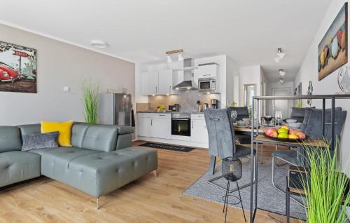 a kitchen and living room with a couch and a table at Hafendiamant in Olpenitz