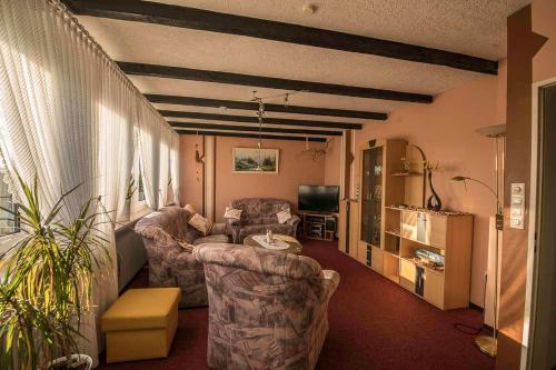 a living room with two chairs and a couch at Ferienwohnung Schoon, 85042 in Ostrhauderfehn