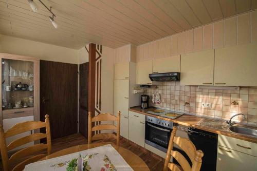 a kitchen with a table and a stove top oven at Ferienwohnung Schoon, 85042 in Ostrhauderfehn