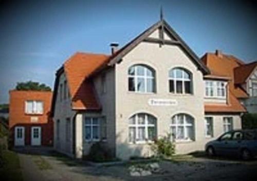 a house with a car parked in front of it at Haus Dornröschen in Koserow