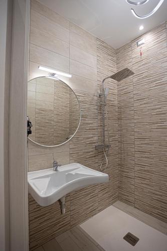 a bathroom with a sink and a mirror at Monia Rooms&Hospitality in Piazza Armerina