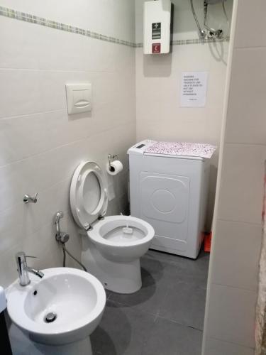 a bathroom with a toilet and a sink at Unique white stone Studio in Giovinazzo