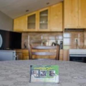 a kitchen with a book on top of a counter at Guesthouse Juli in Sapareva Banya