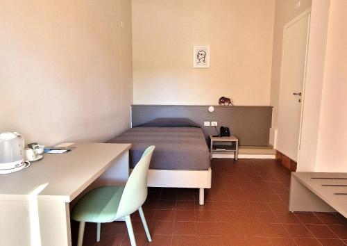 a bedroom with a bed and a table and chairs at Locanda La Cavallina in Brisighella