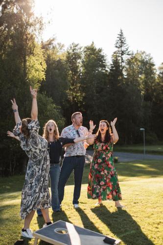 a group of people standing in the grass with their hands in the air at Gråbogården event and conference center in Gråbo