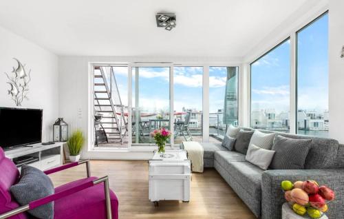 a living room with a couch and a large window at Ankerplatz19B in Olpenitz