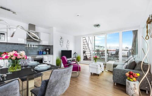a living room with a dining table and a living room at Ankerplatz19B in Olpenitz