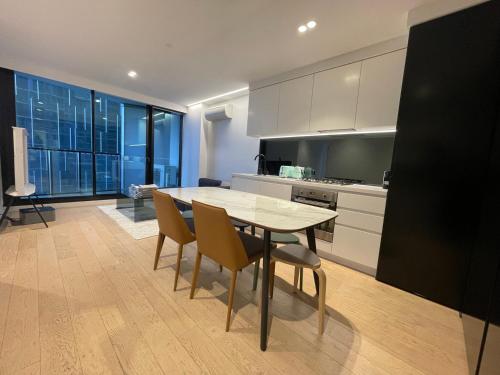 a kitchen with a table and chairs in a room at C&S Stay- Melbourne CBD in Melbourne