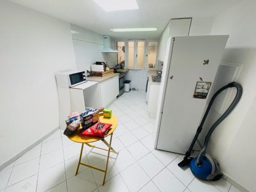 a kitchen with a small table and a refrigerator at Monaco Cote d Azur in Beausoleil