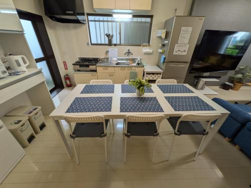 a kitchen with a table and chairs in a room at Villa Castle Ginza ヴィラ キャッスル 銀座 in Hikone