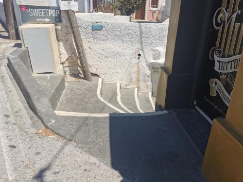 a statue of a dog walking down a stairs at Sweet Pop in Fira