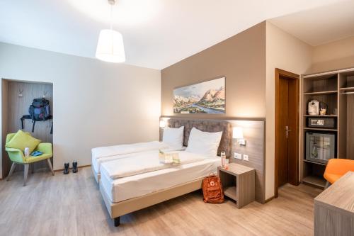 a hotel room with a bed and a chair at Hotel Unione in Bellinzona