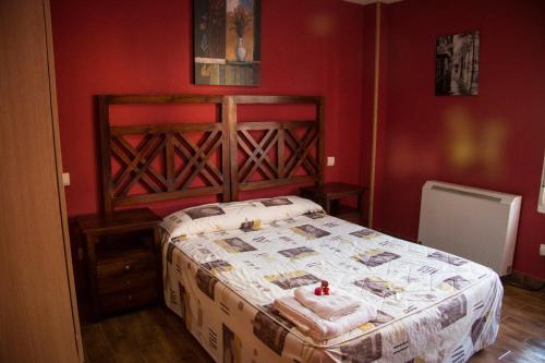 a bedroom with a bed in a red room at Apartahotel Rural CollaRubio Luxury in Collado Mediano