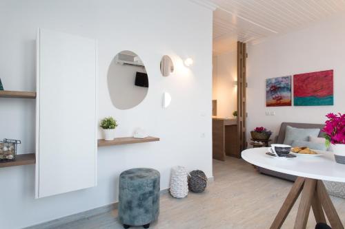 a living room with a table and a couch at Aurora - Rooms & Suites - Spetses in Spetses