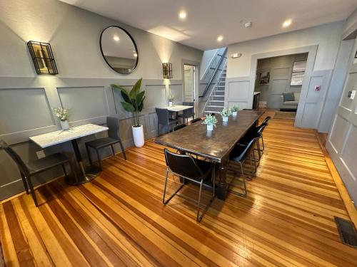 a room with a table and chairs and a staircase at Entire Modern 7 Unit 7 Bath Boutique Inn in Newport