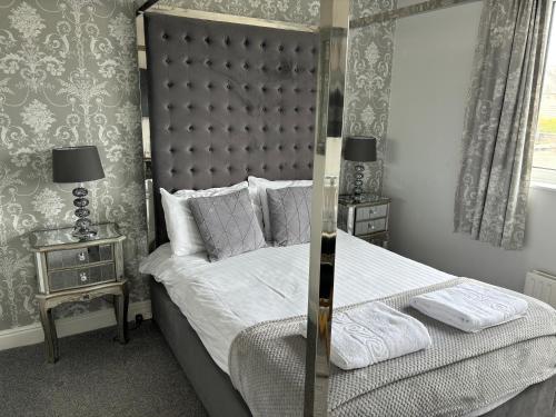 a bedroom with a large bed with a mirror at Solway Lodge Hotel in Gretna Green
