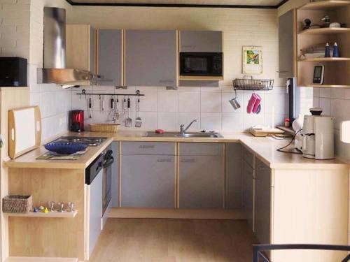a kitchen with a sink and a counter top at Ferienhaus Hinter dem Deich in Tossenserdeich