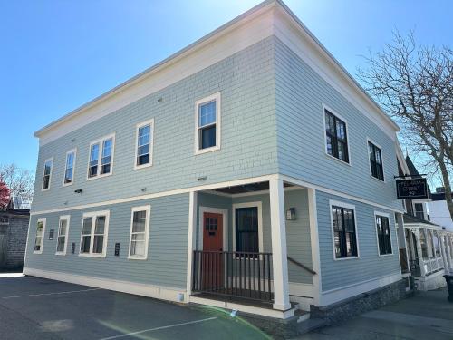a gray house with a red door on a street at Entire Modern 7 Unit 7 Bath Boutique Inn in Newport