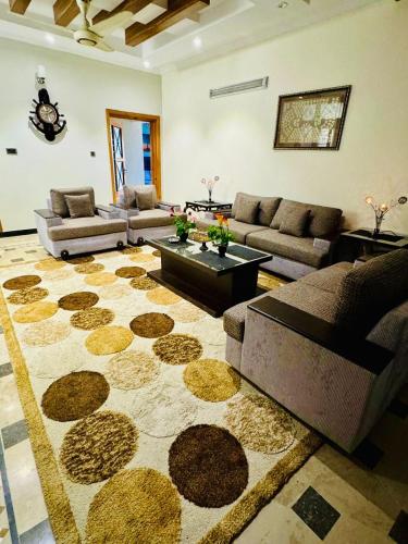 a living room with a couch and a table at Areej heights in Abbottabad